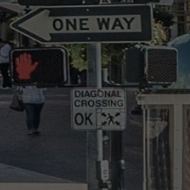 Urban street scene with traffic signals and pedestrians.