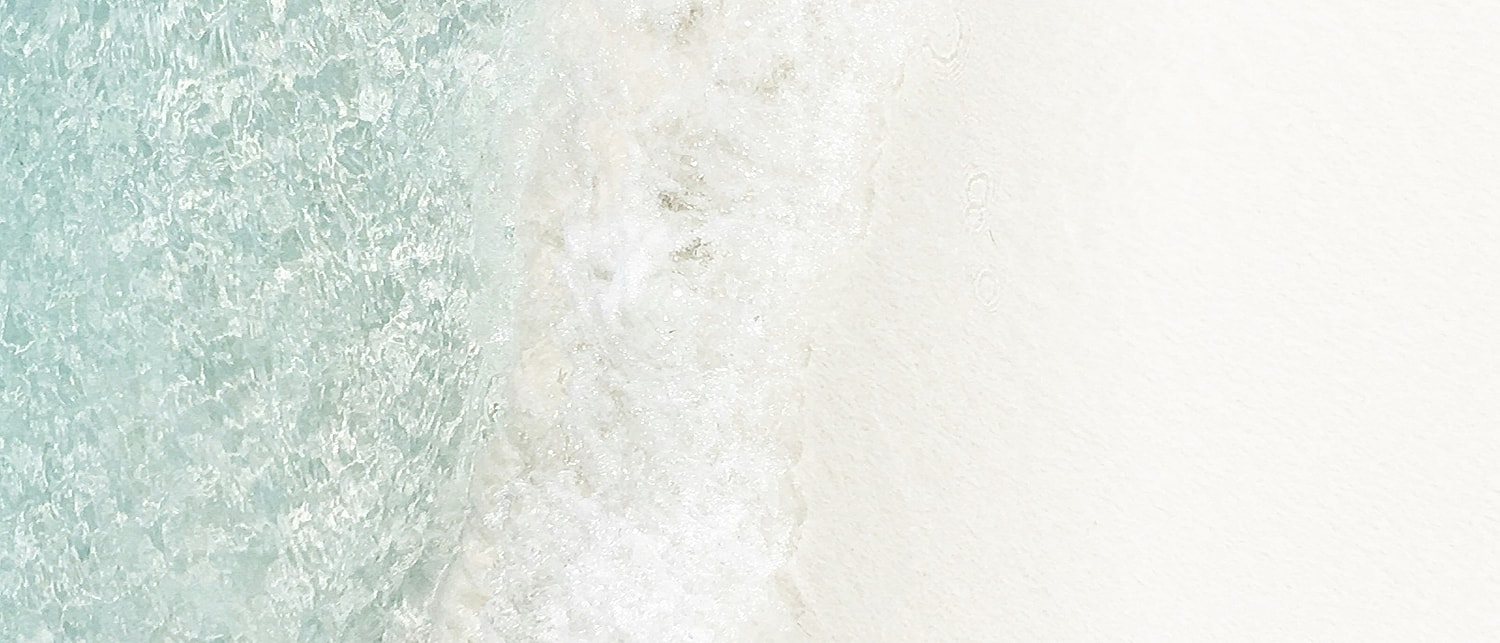 Ocean waves meeting pristine sandy shore.