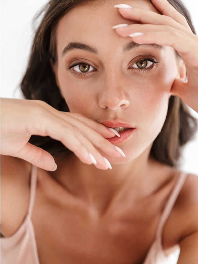 Woman with long hair and elegant makeup.