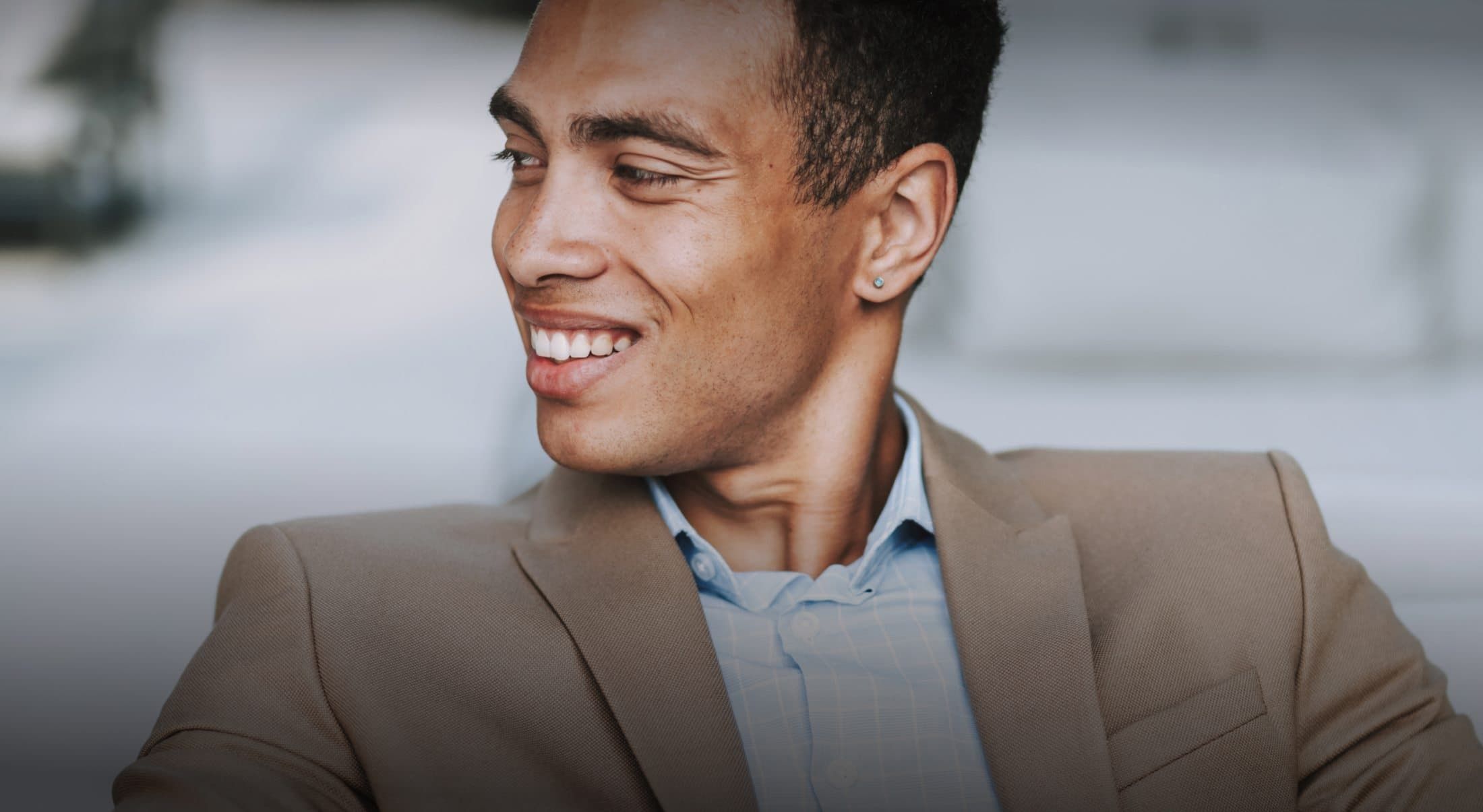 Smiling man in a casual business suit.