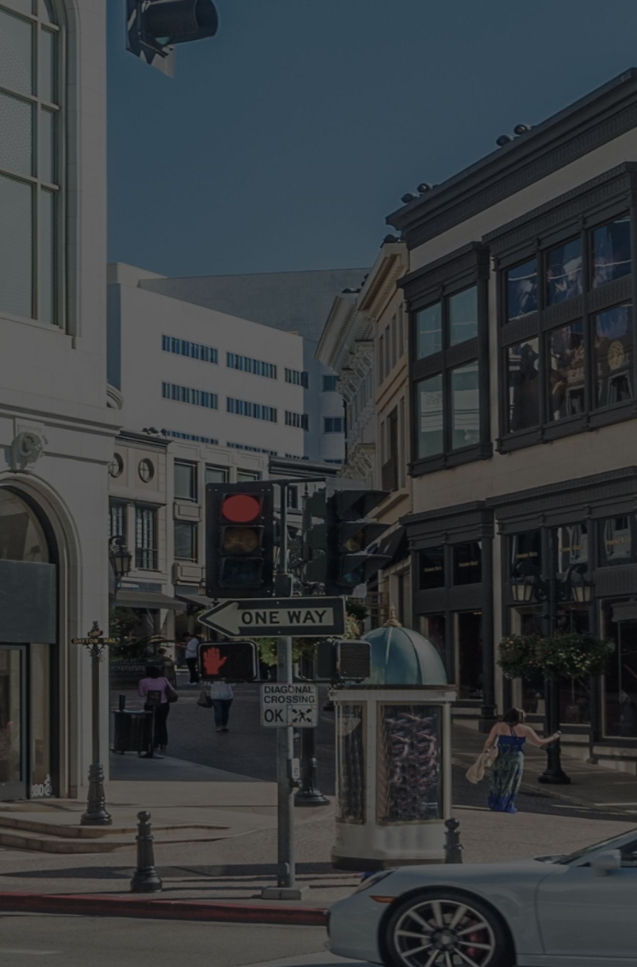 City street with shops and traffic signals.